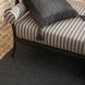 Surya Antibes outdoor bench with brown and beige striped Sunbrella upholstery and black aluminum base.