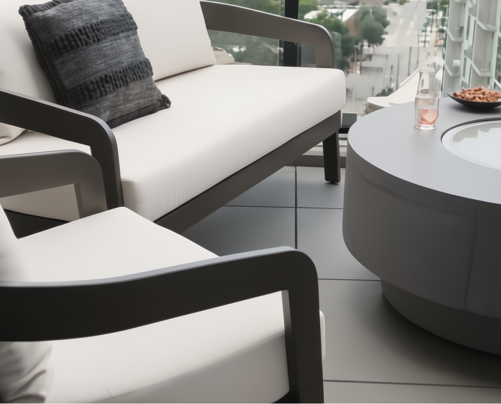 Surya Daniella outdoor loveseat and armchair with white Sunbrella cushions and gray aluminum frames.