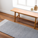 Hand-woven Surya Abby ABB-2300 light gray recycled PET yarn area rug on a wood floor.