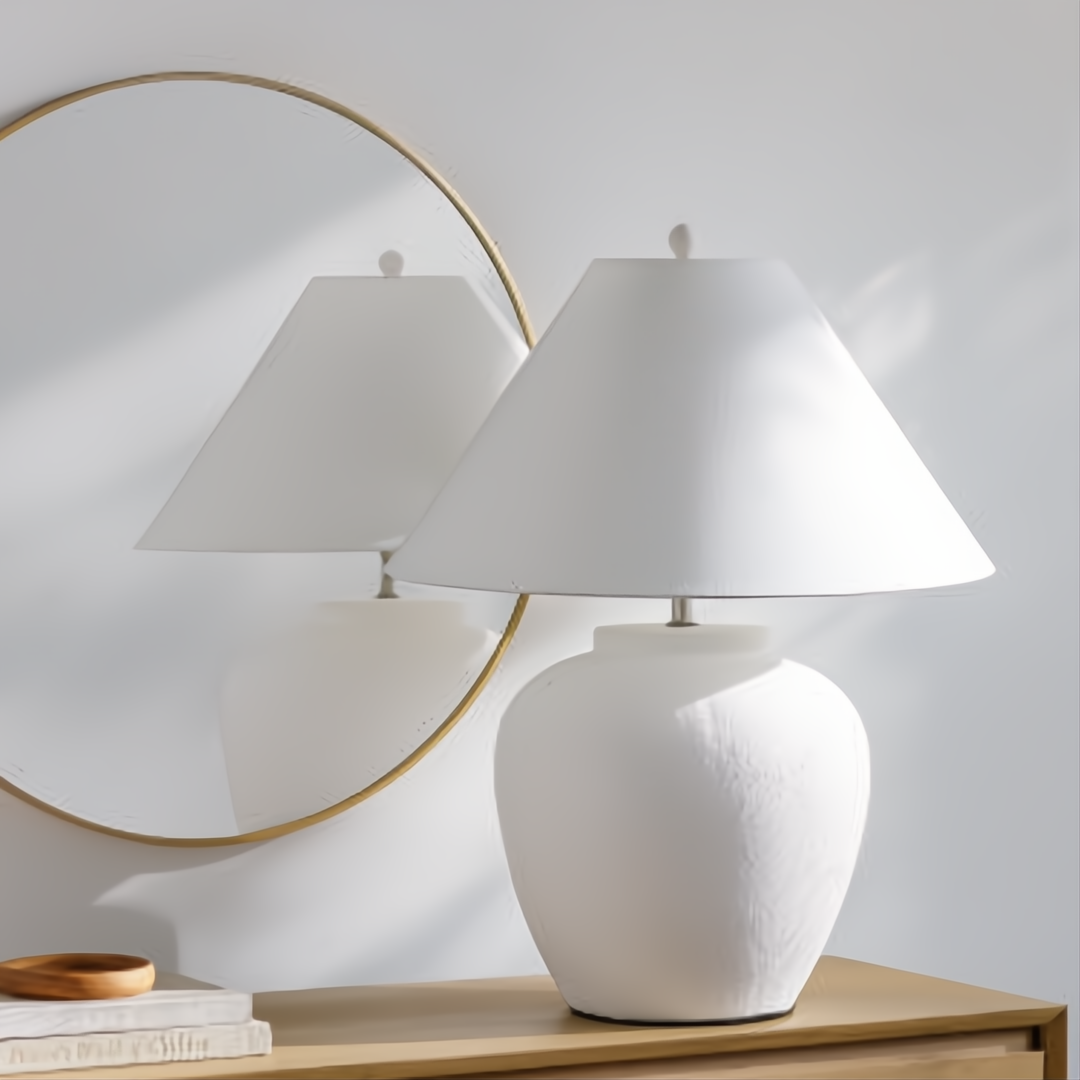 Surya Arion accent table lamp with a cream ceramic base and white linen shade.
