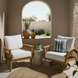 Two Surya Cape Town accent chairs with white Sunbrella cushions and wheat aluminum bases on a patio.