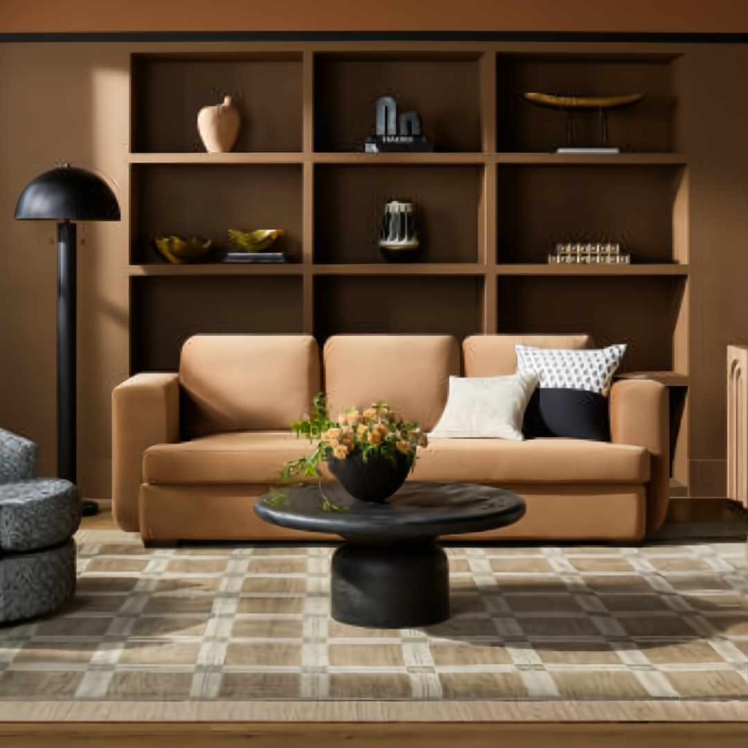 Black sandblasted mango wood round coffee table with a turned base in a living room setting.