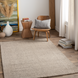 Surya Aiden AEN-1005 medium pile wool area rug in Gray and Ivory, styled in a modern living space.