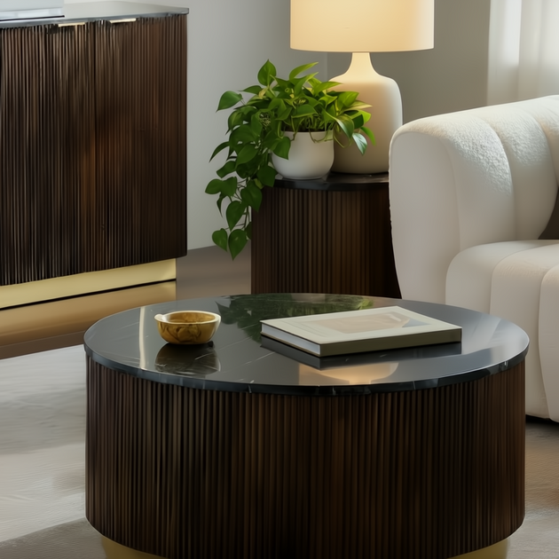 Round Surya Nems coffee table with black polished marble top, dark brown mango wood base, and gold brass accents.