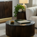 Round Surya Nems coffee table with black polished marble top, dark brown mango wood base, and gold brass accents.