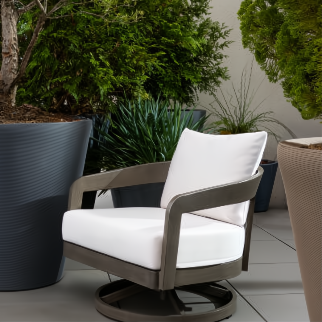 Gray Surya Daniella outdoor swivel chair with white Sunbrella cushions and a hand-painted aluminum base.