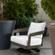 Gray Surya Daniella outdoor swivel chair with white Sunbrella cushions and a hand-painted aluminum base.