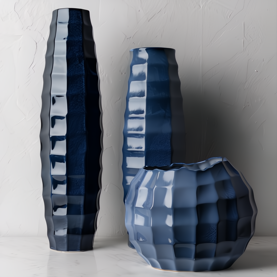 Three modern Surya Cirio ceramic vases in varying shades of blue with a textured, sculptural design.