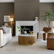 Surya Nems round coffee table with white marble top, reeded brown mango wood base, and gold accents in a living room.