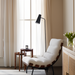 Surya Laval Accent Chair, modern oatmeal upholstered lounger with a black iron base and wood accents.