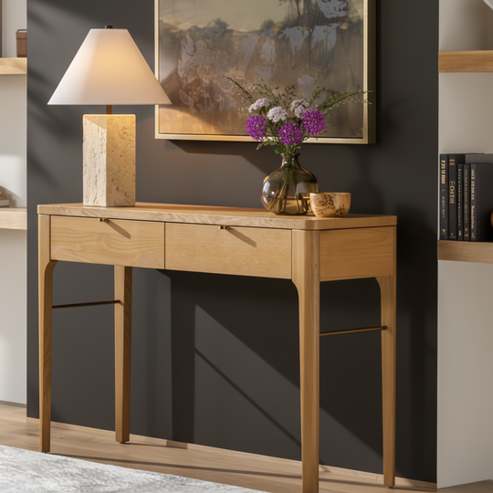 Slim brown oak veneer console table with two drawers and a brown/metallic brass base.