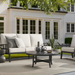 Surya Fairborn outdoor accent chair with black aluminum base and cream Sunbrella cushions.