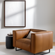 Modern Surya Dylan accent chair with brown leather, black iron base, and a light pillow.