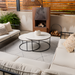 Cream glazed ceramic Surya Cirio outdoor vase set on a modern patio coffee table.