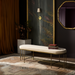 Surya Engel bench with a long, streamlined beige polyester top and metallic brass iron base.