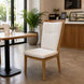 Surya Cape Town outdoor dining chair with wheat finish aluminum frame and white Sunbrella cushions.