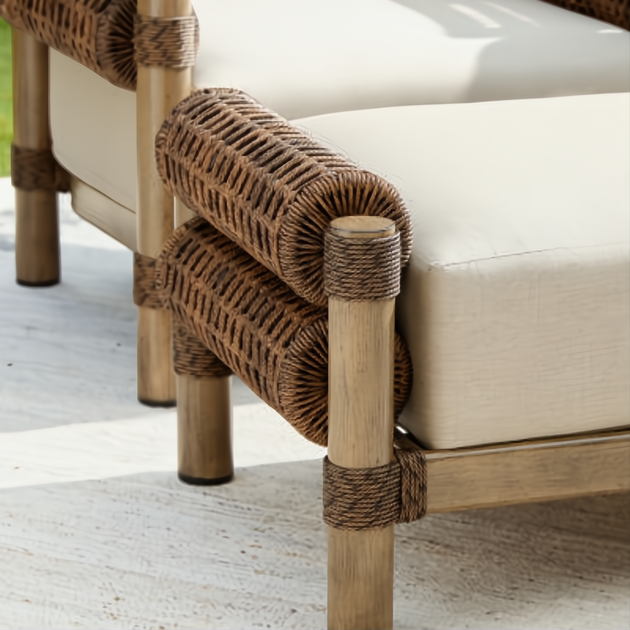 Close-up of a Surya Porta Ottoman with a beige Sunbrella cushion and brown woven accents on a light wood frame.