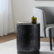 Surya Amenet round end table with black antiqued powder-coated iron base and hammered detailing.