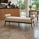 Surya Antibes outdoor bench with a light beige Sunbrella acrylic cushion and black aluminum base.