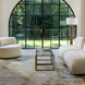 Surya Algarve accent floor lamp with a white linen shade, resin base, and modern design in a living room.