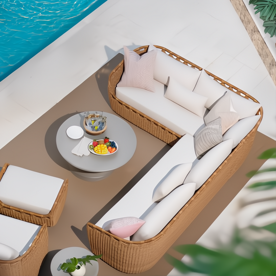 Marvella sectional with light brown woven base, white cushions, and pink pillows on a patio by a pool.