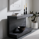 Black brushed mango wood Surya Coburn console table with a soft-close drawer and plinth base.