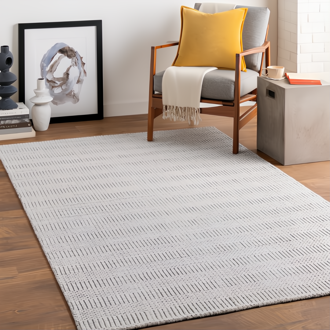 Surya Hickory HCK-2302-P area rug in light beige, gray, and charcoal with a subtle chevron pattern.