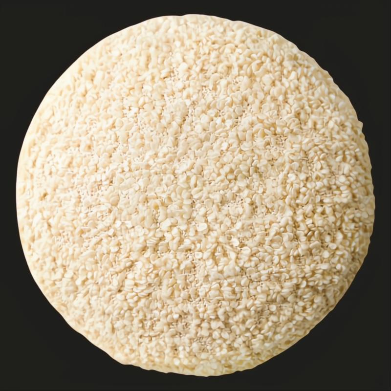 Close-up of a round, textured, light beige pouf with a woven polyester surface.