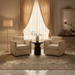 Black mango wood Koben end table with a turned base, centered between two cream armchairs.