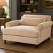 Surya Elowena Accent Chair, a wide, comfortable beige polyester upholstered chair with dark brown rubber wood legs.