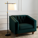 Modern black and gold floor lamp with an ivory linen shade next to a dark green velvet accent chair.