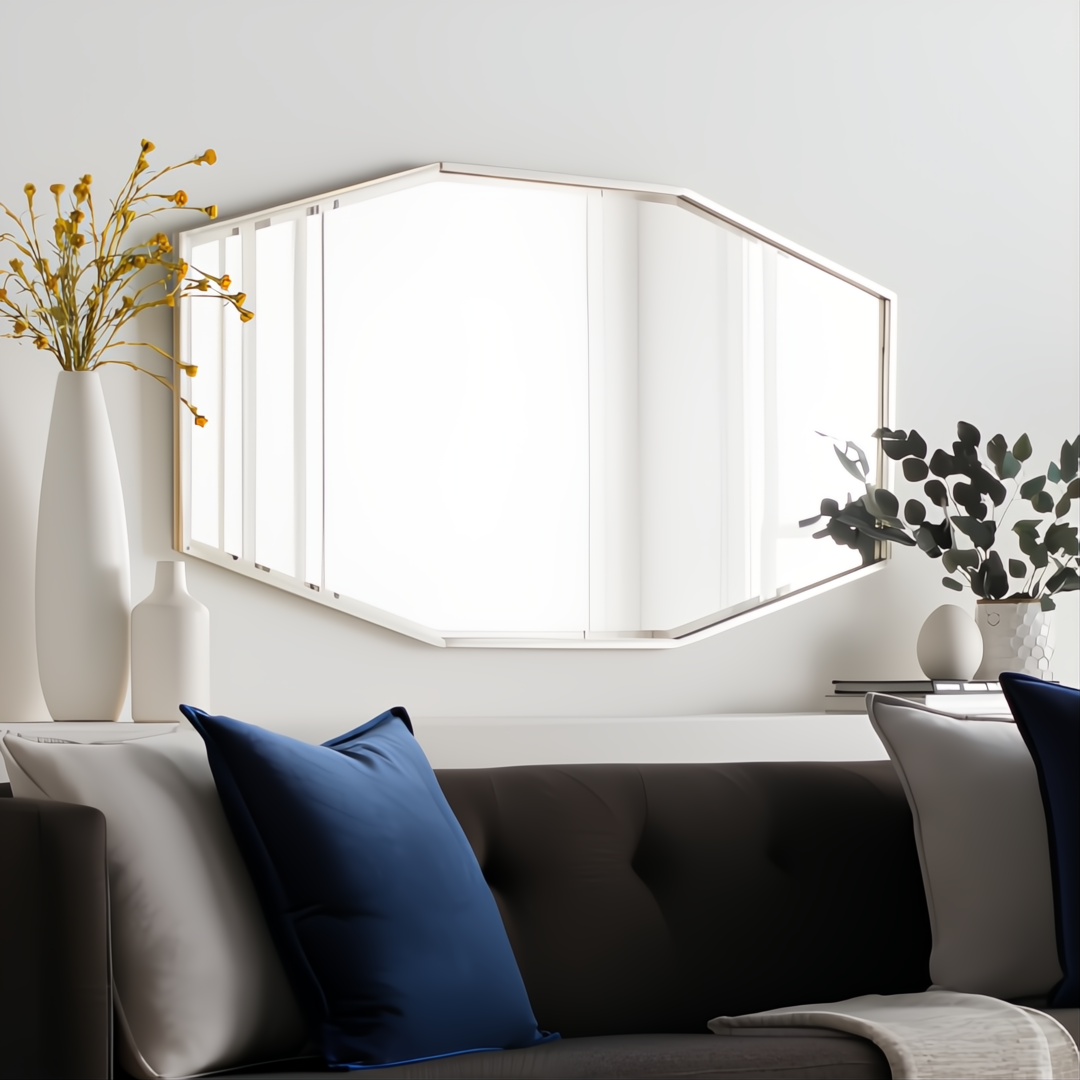 Modern hexagonal wall mirror with a gilded metallic silver iron frame above a dark sofa.