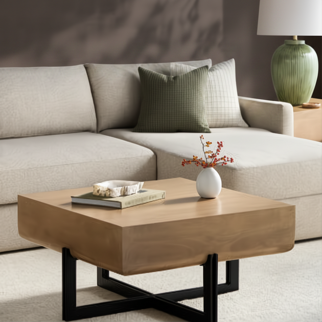 Surya Lowmax coffee table with a brown mango wood top and black cast iron base in a living room.