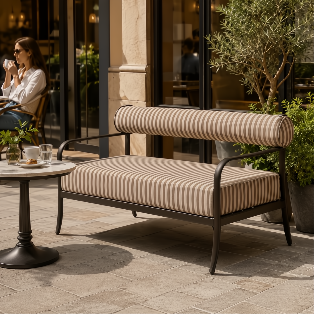Surya Antibes Loveseat with striped Sunbrella acrylic cushions and black aluminum frame on a patio.