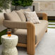 Surya Palma outdoor sofa with tan Sunbrella upholstery, teak frame, PE rope details, and a decorative pillow.