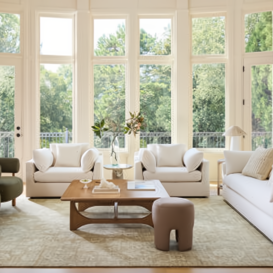 Surya Capitola white upholstered accent chairs and sofa in a bright living room.