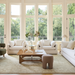 Surya Capitola white upholstered accent chairs and sofa in a bright living room.