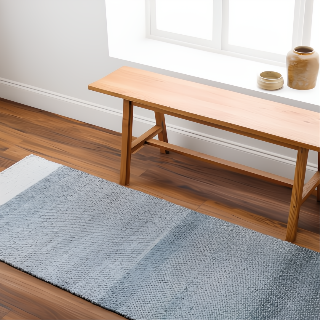 Hand-woven Surya Abby ABB-2302 area rug in blue and white recycled PET yarn, next to a wooden bench.
