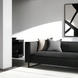 Surya Dylan charcoal top-grain leather sofa with black iron base, two decorative pillows, and modern art.