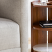Surya Gerald End Table with dark brown mango wood top, marble, and brass base, next to a light gray sofa.