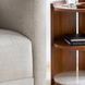 Surya Gerald End Table with dark brown mango wood top, marble, and brass base, next to a light gray sofa.