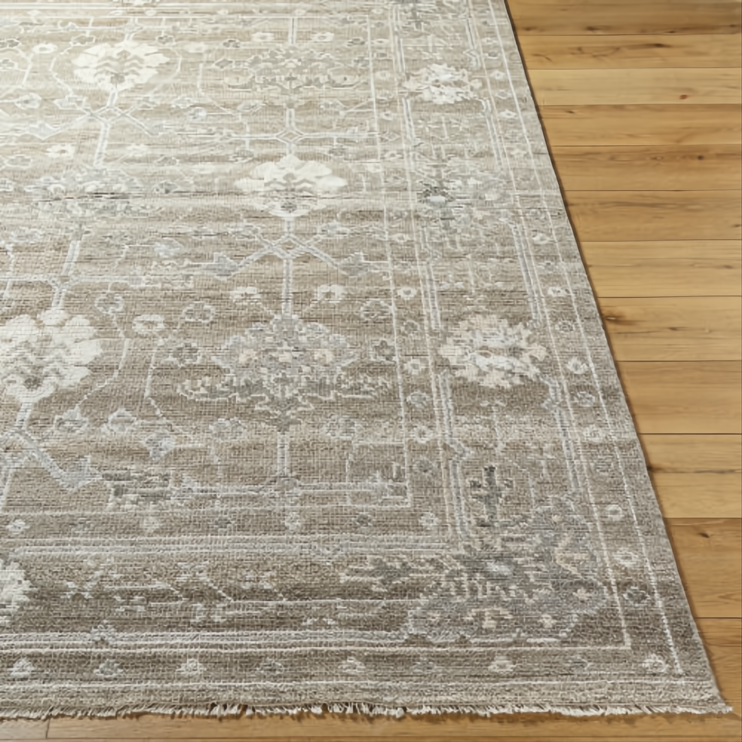 Surya Almeria low pile hand-knotted rug in light brown, medium gray, and cream with fringe.