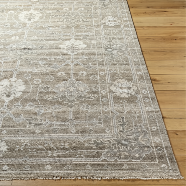 Surya Almeria low pile hand-knotted rug in light brown, medium gray, and cream with fringe.