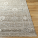 Surya Almeria low pile hand-knotted rug in light brown, medium gray, and cream with fringe.