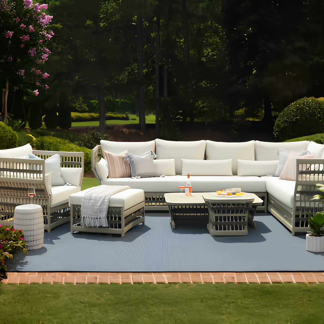 Winder Sectional Left Arm in cream Sunbrella acrylic with aluminum base, shown in an outdoor lounge setting.