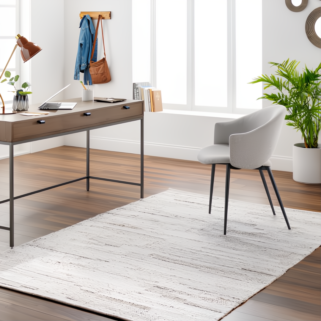 Light beige Surya Floria hand-woven recycled PET rug in a modern home office with a desk and chair.