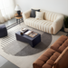 Surya Neemrana black brushed acacia wood coffee table in a modern living room setting.