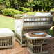 Cream Surya Winder accent chair with Sunbrella cushions, matching ottoman, and side table on a brick patio.
