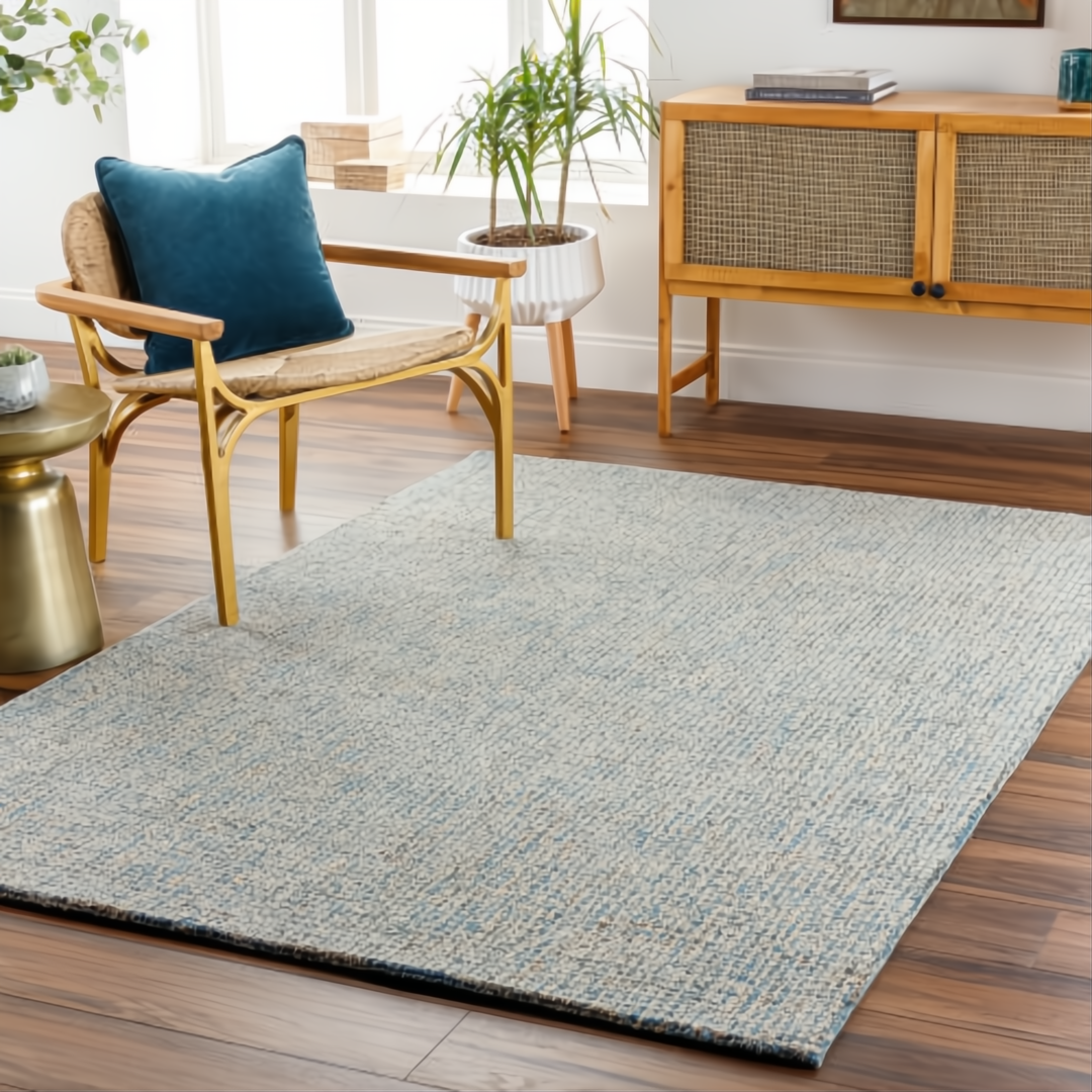 Surya Aiden AEN-1001 hand-tufted wool area rug in light blue and cream, on a dark wood floor.