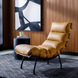 Surya Laval modern accent chair with brown leather cover, black lacquered iron base, and deep lounge-style seating.